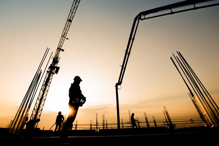 Construction worker concrete pouring commercial building via remote